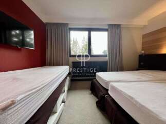 Discover a cozy bedroom featuring multiple beds, perfect for accommodating guests.