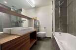 Modern bathroom design featuring a sleek vanity with a double sink and ample storage.