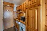 Discover a charming kitchen with warm wooden cabinetry, perfect for creating a cozy atmosphere.