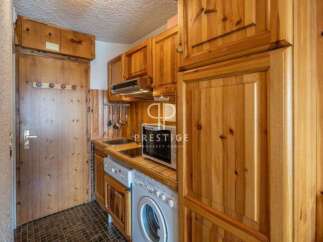 Discover a charming kitchen with warm wooden cabinetry, perfect for creating a cozy atmosphere.