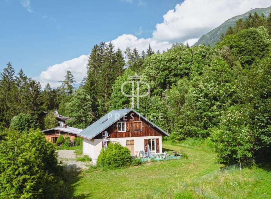 Discover a charming chalet nestled in a serene, green landscape.