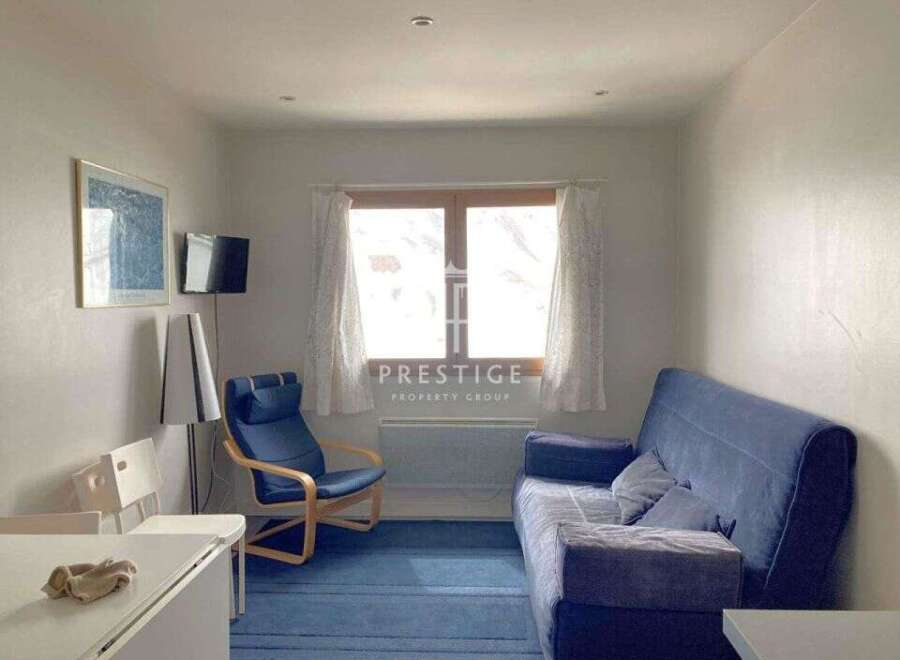 Cozy living space with a comfortable blue sofa, perfect for relaxation.