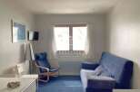 Cozy living space with a comfortable blue sofa, perfect for relaxation.
