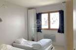 Discover a cozy bedroom featuring two comfortable beds, perfect for a relaxing stay.