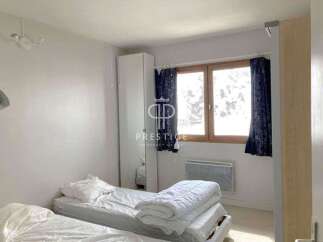 Discover a cozy bedroom featuring two comfortable beds, perfect for a relaxing stay.