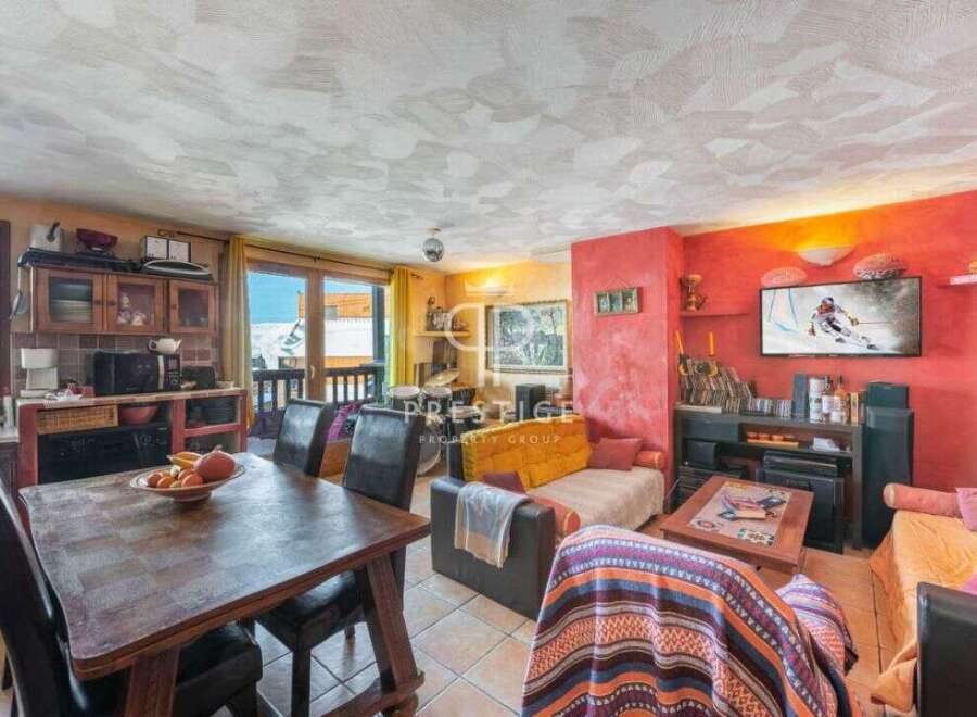 Discover a cozy living space with a rustic dining table and comfortable seating.