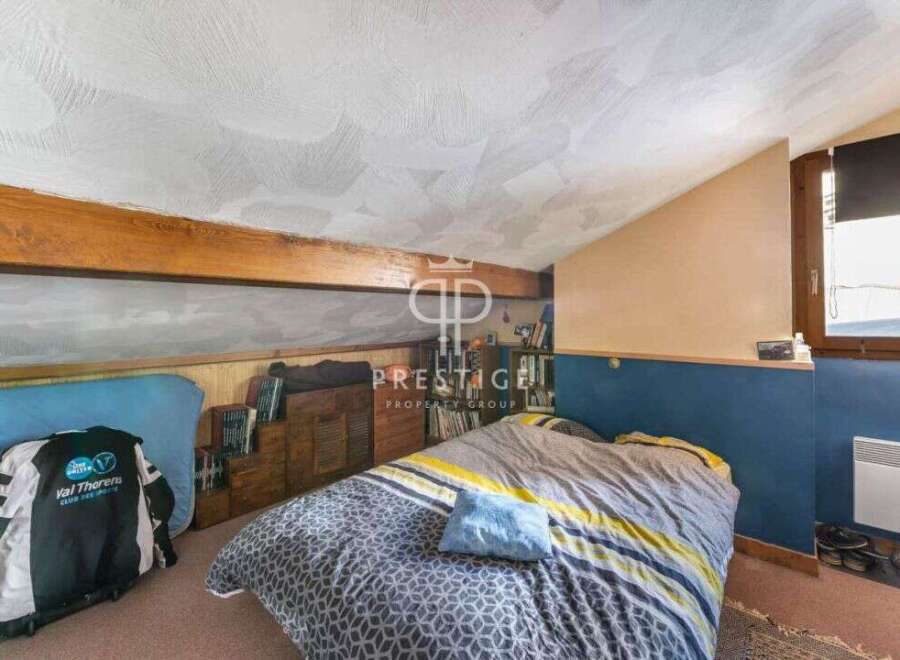 Discover this charming attic bedroom, perfect for a cozy retreat.