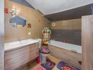 Discover this charming bathroom featuring a stylish vanity and a modern sink.