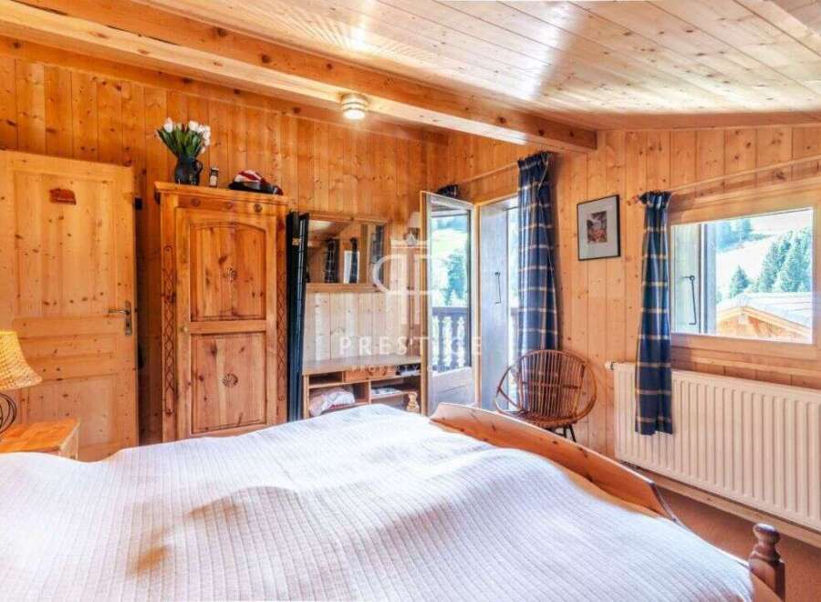 Experience the warmth of this charming wooden bedroom.