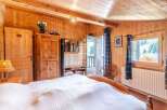 Experience the warmth of this charming wooden bedroom.