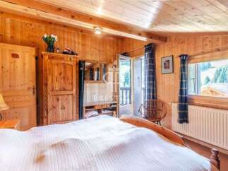 Experience the warmth of this charming wooden bedroom.