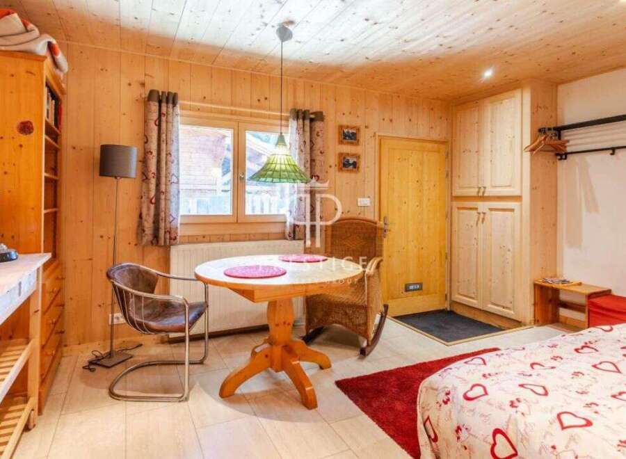 Cozy chalet-style interior with wooden walls and ceiling.