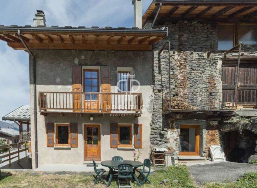 Discover the charm of this stunning property, featuring a rustic stone facade and inviting wooden accents.