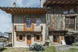 Discover the charm of this stunning property, featuring a rustic stone facade and inviting wooden accents.