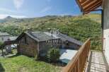 Discover a charming stone house nestled in a picturesque mountain setting.
