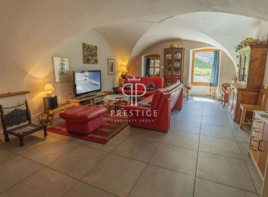 Discover the charm of this unique property, featuring a cozy living room with a distinctive arched ceiling.