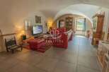 Discover the charm of this unique property, featuring a cozy living room with a distinctive arched ceiling.