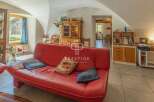 Discover the charm of this stunning property, featuring a spacious living area with a vibrant red sofa.