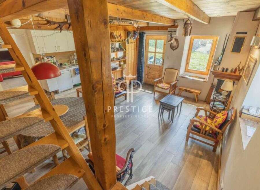 Discover rustic charm in this cozy home! Featuring a unique wooden staircase and exposed beams, this property exudes warmth and character.