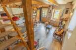 Discover rustic charm in this cozy home! Featuring a unique wooden staircase and exposed beams, this property exudes warmth and character.