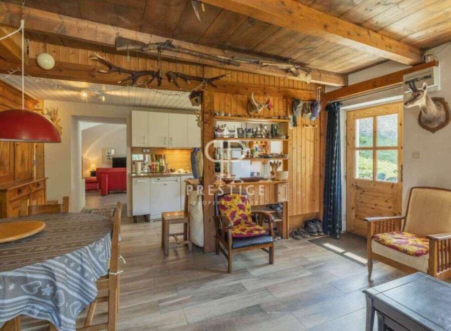 Step into a charming rustic retreat! This property boasts a warm and inviting interior with exposed wooden beams and a cozy atmosphere.
