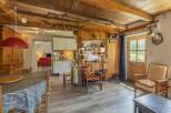 Step into a charming rustic retreat! This property boasts a warm and inviting interior with exposed wooden beams and a cozy atmosphere.