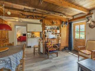 Step into a charming rustic retreat! This property boasts a warm and inviting interior with exposed wooden beams and a cozy atmosphere.