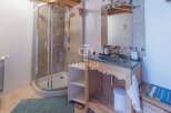 Discover a charming bathroom with a modern shower and a stylish vanity.
