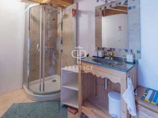Discover a charming bathroom with a modern shower and a stylish vanity.