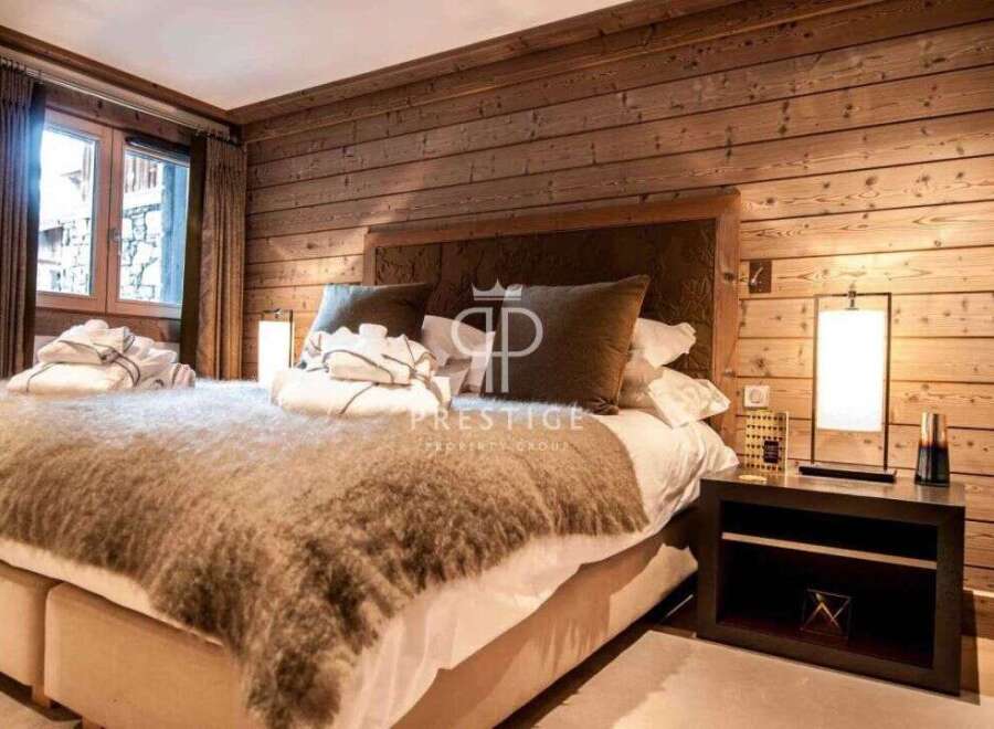 Experience luxury in this stunning bedroom featuring a cozy, oversized bed with a plush, textured throw.
