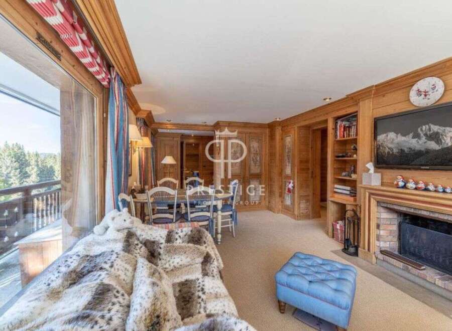 Experience luxury living in this stunning property, featuring a cozy fireplace and elegant wooden accents throughout.