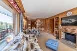 Experience luxury living in this stunning property, featuring a cozy fireplace and elegant wooden accents throughout.