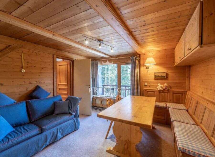 Step into a cozy retreat with this charming wooden interior.