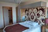 Discover a stylish bedroom with a unique headboard design.
