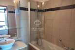 This bathroom features a modern design with a sleek glass shower enclosure.