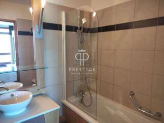 This bathroom features a modern design with a sleek glass shower enclosure.