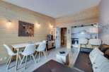 Discover a cozy retreat in this charming property, featuring a warm wooden interior and a stylish living space.