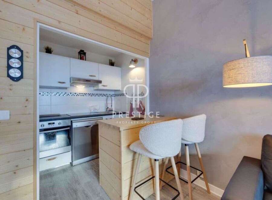 Discover a cozy and stylish apartment with a modern kitchen and a breakfast bar, perfect for intimate meals.