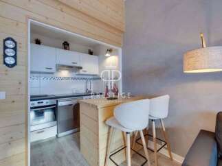 Discover a cozy and stylish apartment with a modern kitchen and a breakfast bar, perfect for intimate meals.