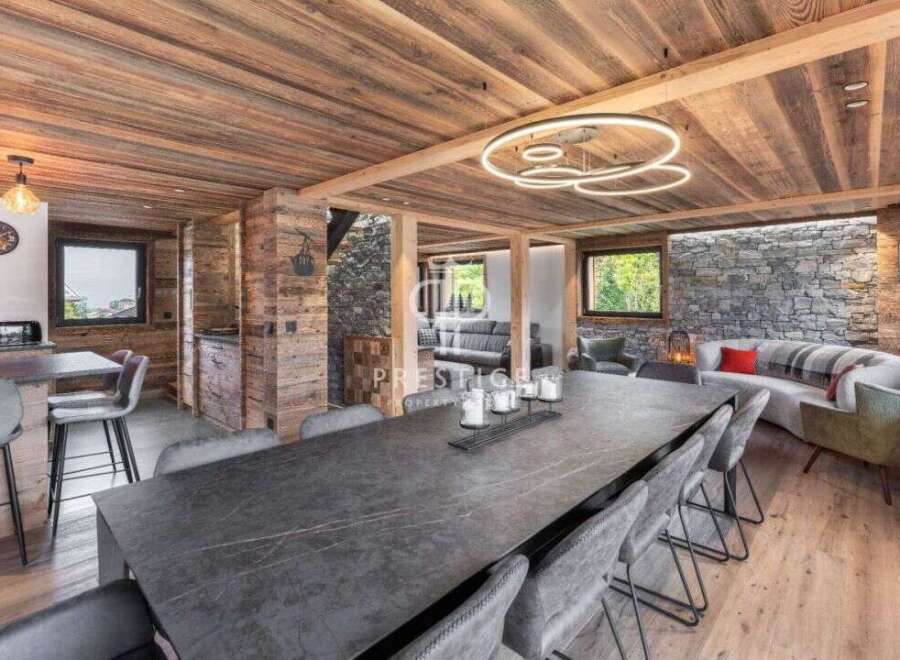 Experience luxury living in this stunning property, featuring a beautifully designed dining area with a large table and comfortable seating.