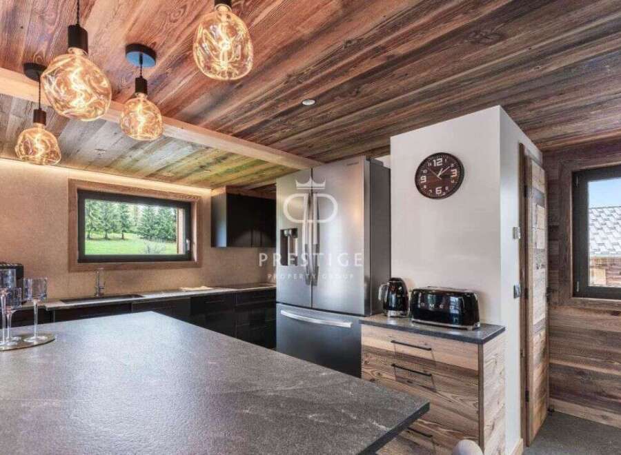 Experience luxury living in this stunning property, featuring a modern kitchen with sleek countertops and stainless steel appliances.