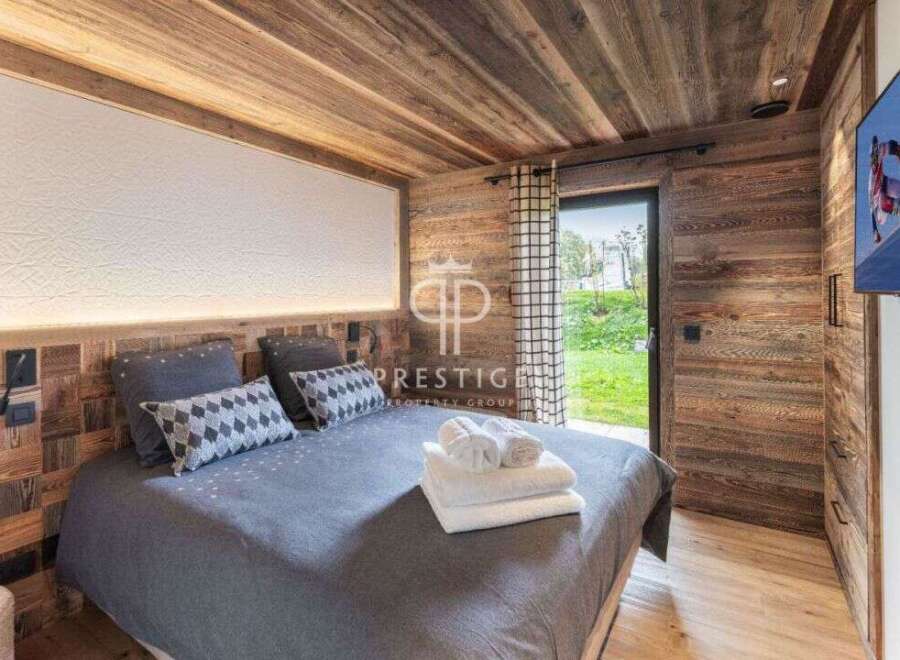 Experience luxury in this stunning bedroom featuring exquisite wooden paneling and a cozy ambiance.