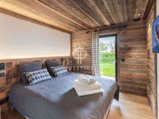 Experience luxury in this stunning bedroom featuring exquisite wooden paneling and a cozy ambiance.