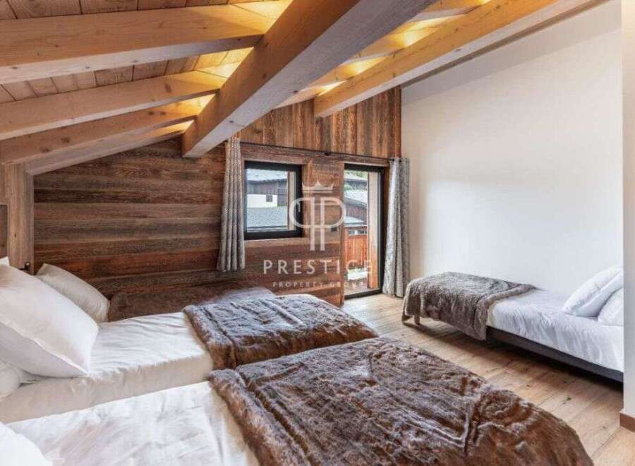 Discover the charm of this cozy bedroom, featuring a rustic wooden ceiling and walls that exude warmth.
