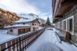 Discover a charming property nestled in a snowy mountain landscape.