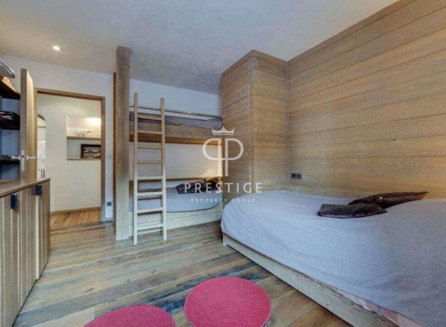 Discover the charm of this cozy bedroom featuring a unique bunk bed design, perfect for maximizing space.