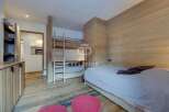 Discover the charm of this cozy bedroom featuring a unique bunk bed design, perfect for maximizing space.