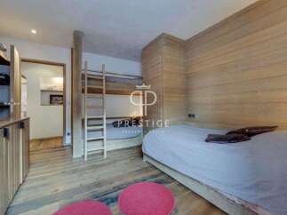 Discover the charm of this cozy bedroom featuring a unique bunk bed design, perfect for maximizing space.