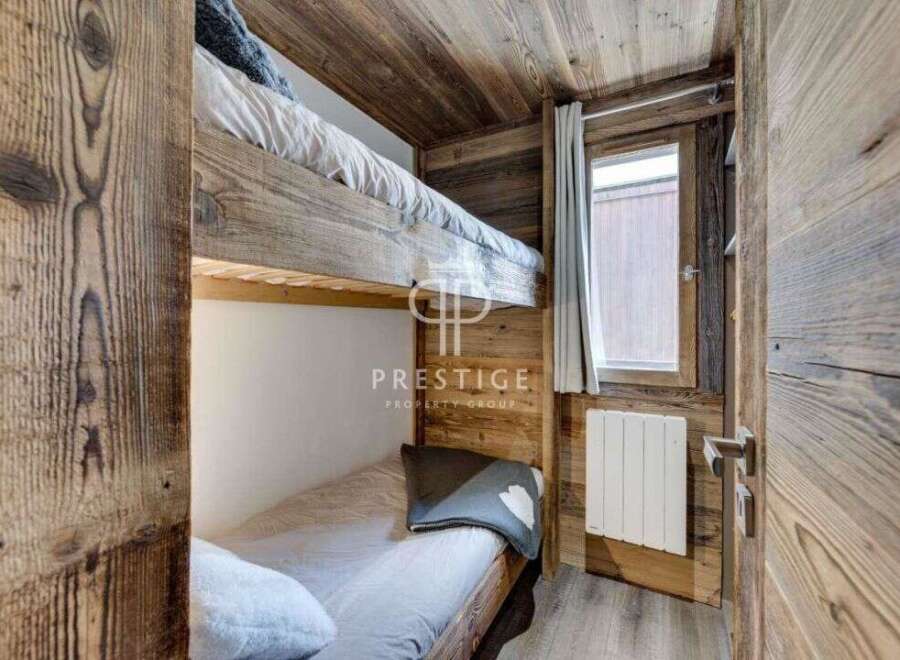 Discover the charm of this cozy bedroom featuring rustic wooden bunk beds, perfect for a mountain retreat.