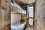 Discover the charm of this cozy bedroom featuring rustic wooden bunk beds, perfect for a mountain retreat.